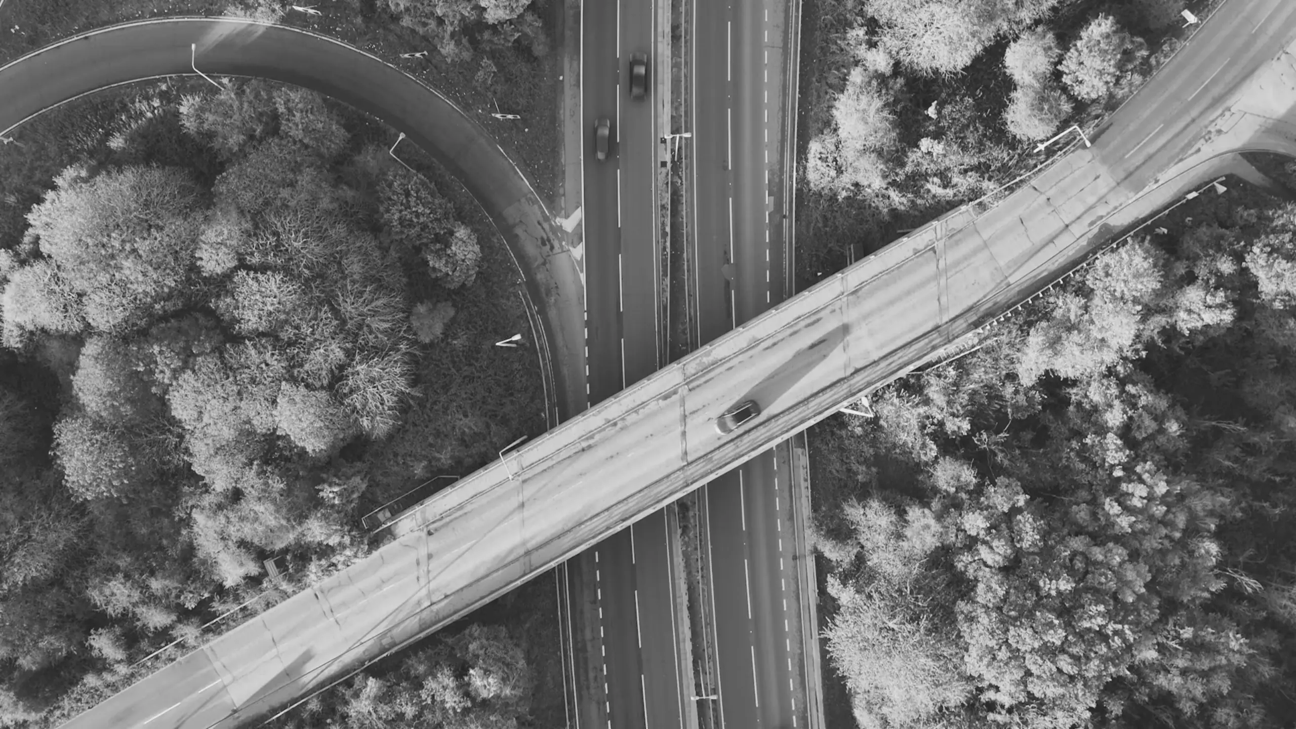 Overhead geometric shot of a bridge crossing the dual carriageway
